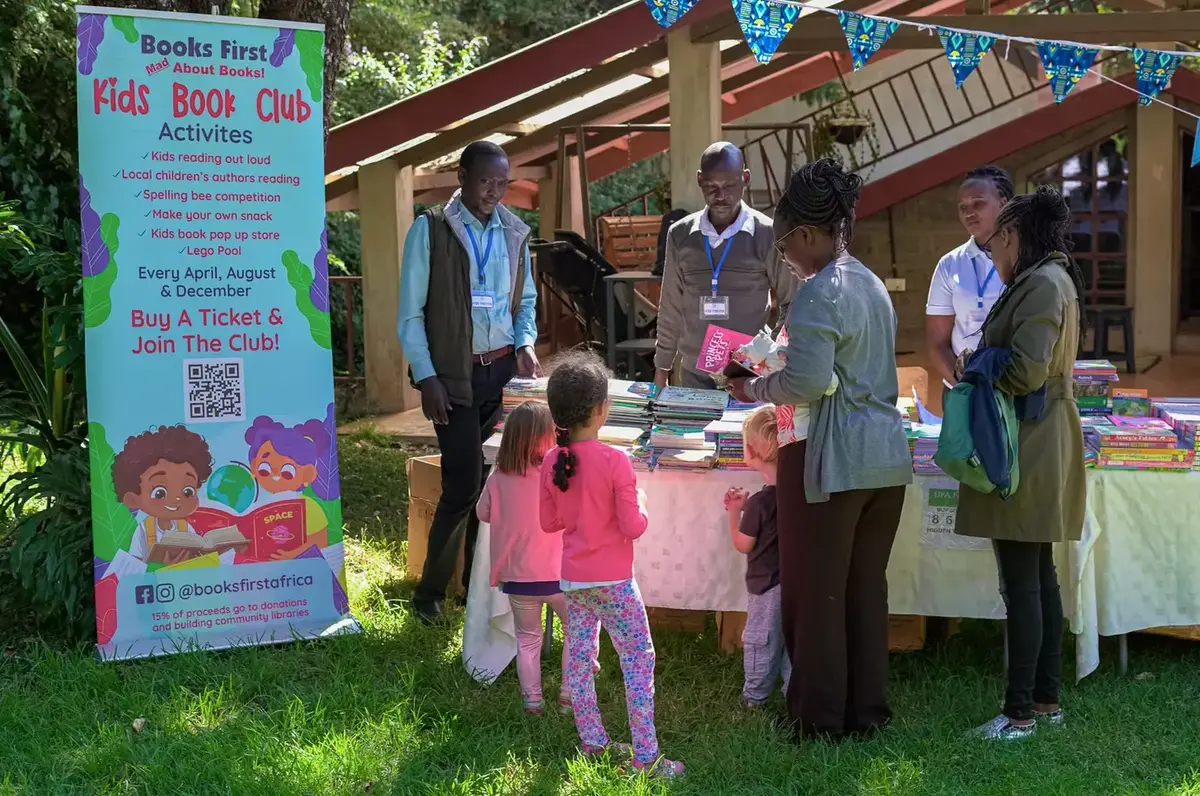 Families and children choosing books at a BooksFirst fair
