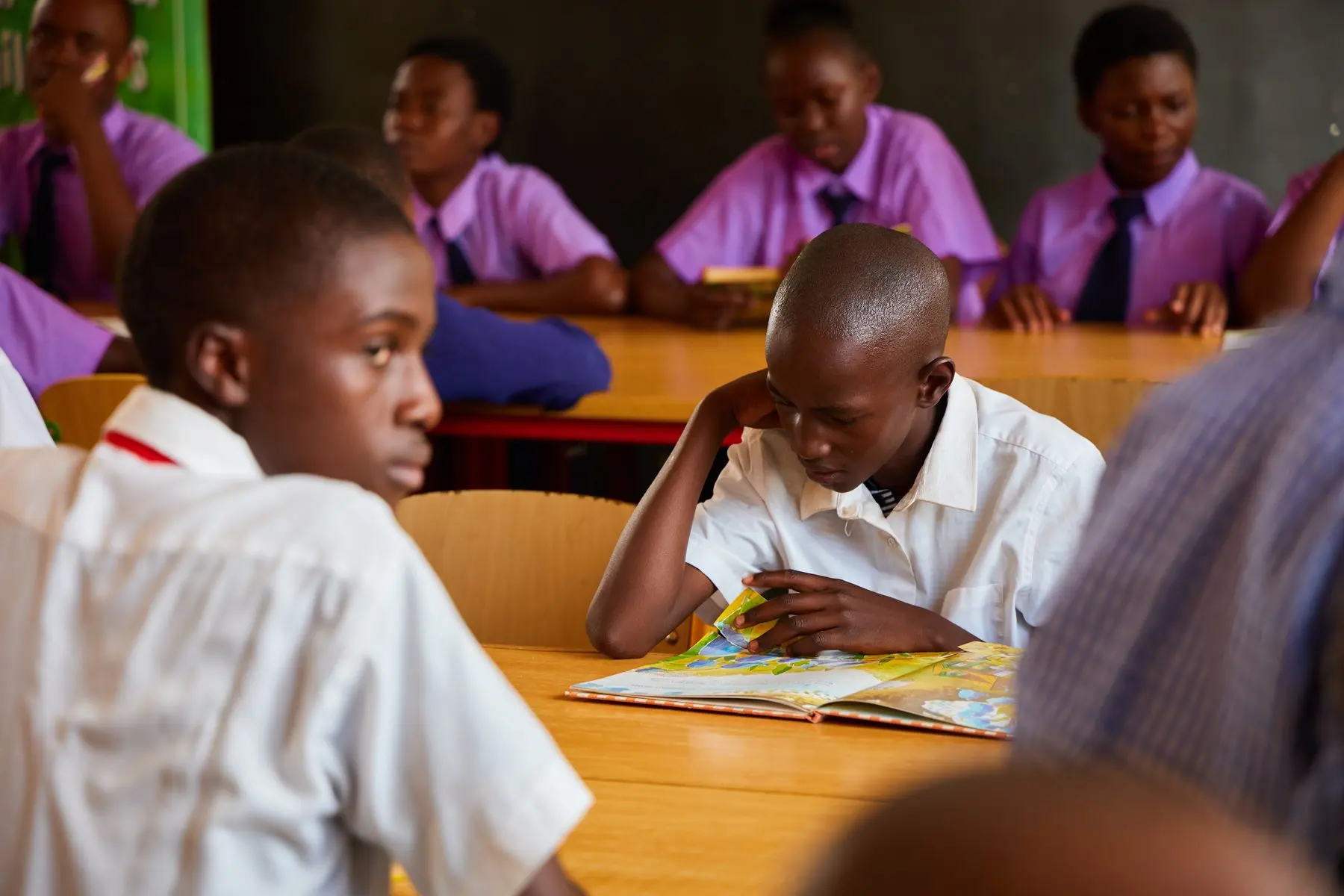 A student reading during a BooksFirst group activity